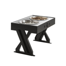 이미지를 갤러리 뷰어에 로드 , Stylish black pet feeding station with two stainless steel bowls, featuring paw print design and a sturdy X-shaped support that can be adjusted according to the pet&#39;s growth

